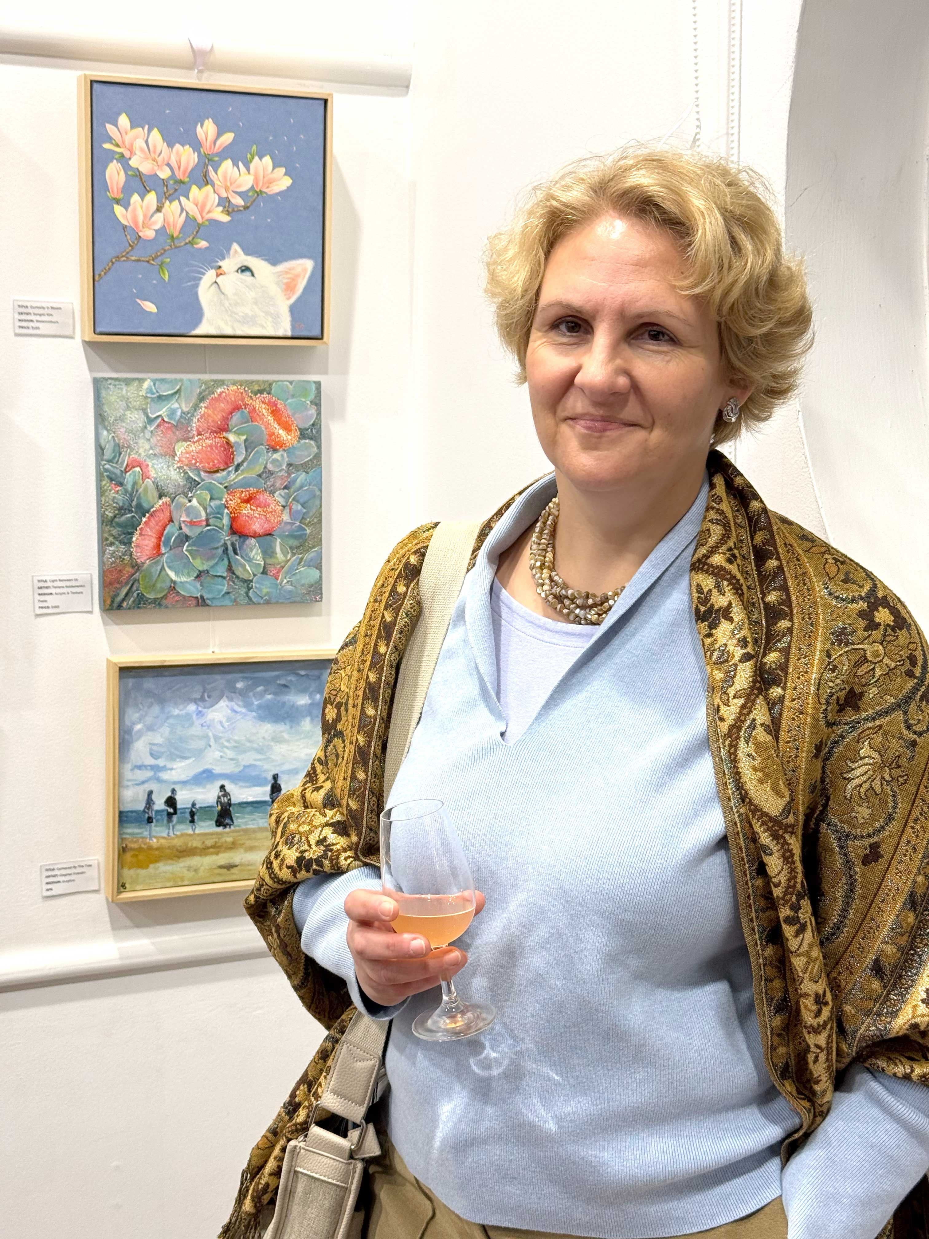 Tetiana Koldunenko in front of her artwork
