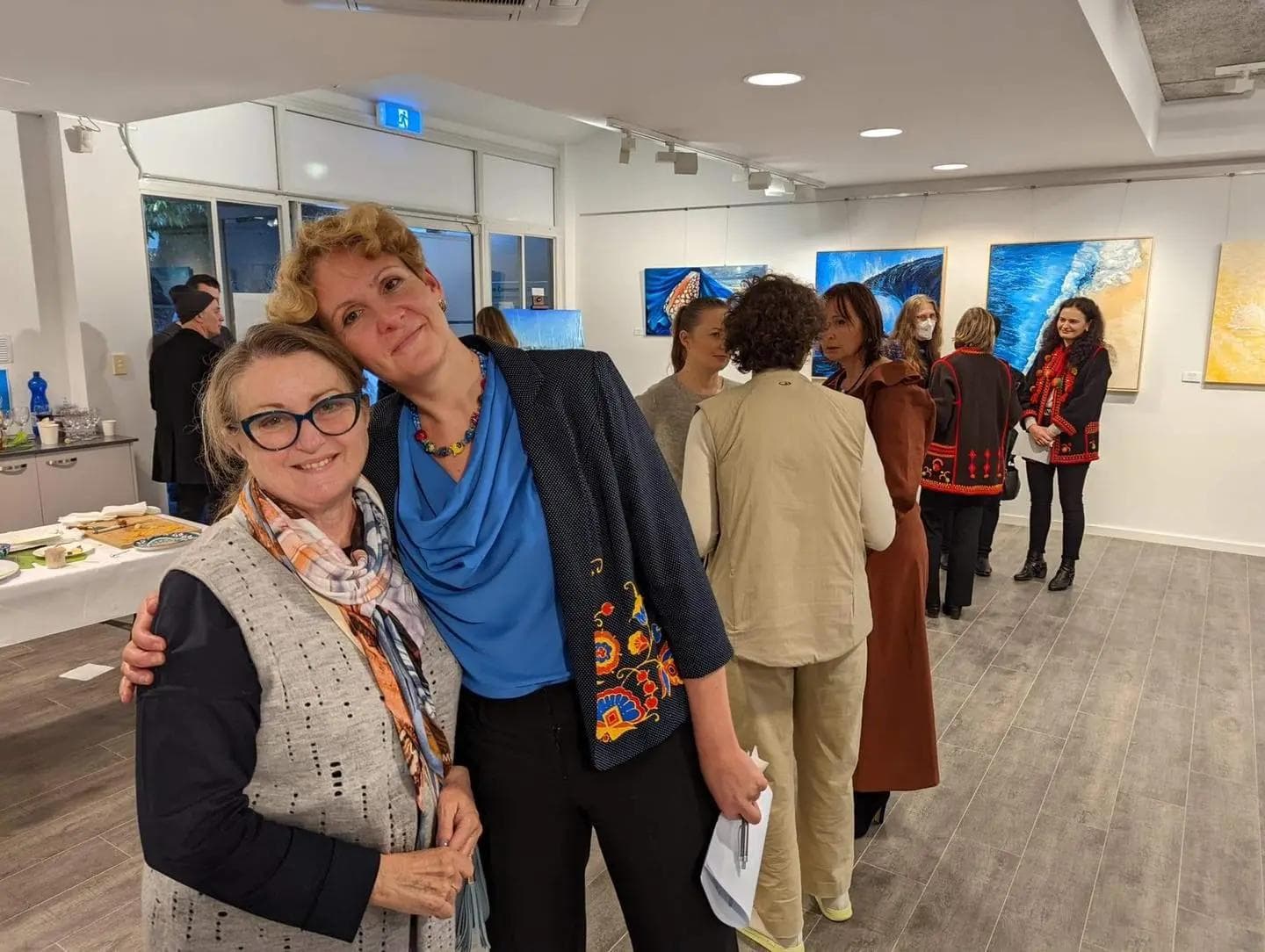 Australian landscape artist Tetiana Koldunenko at her Sydney exhibition, presenting original contemporary paintings