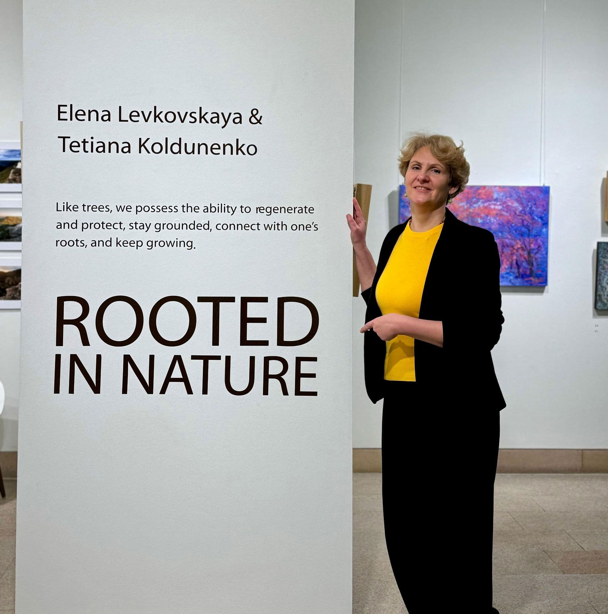 Artist next to the sign