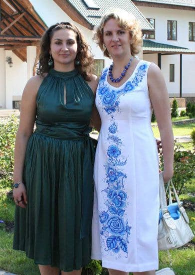 Two ladies, one in white dress with blue flowers