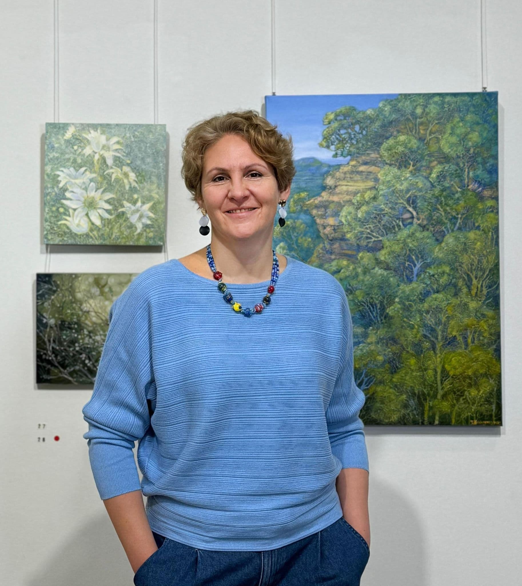 Award winning artist Tetiana Koldunenko next to her artworks