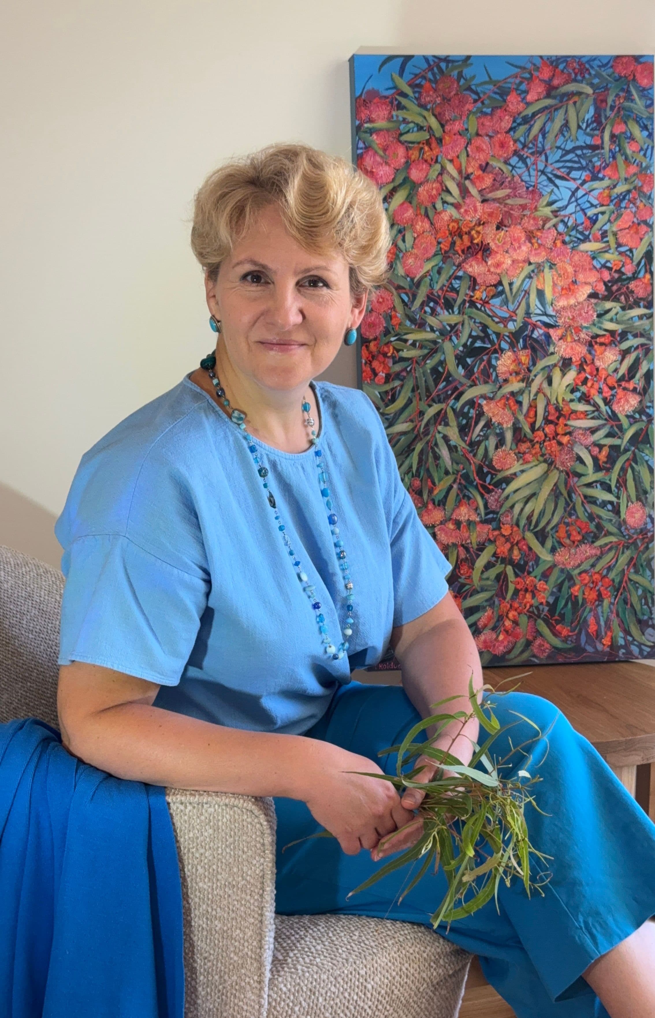 Tetiana Koldunenko in front of her artwork