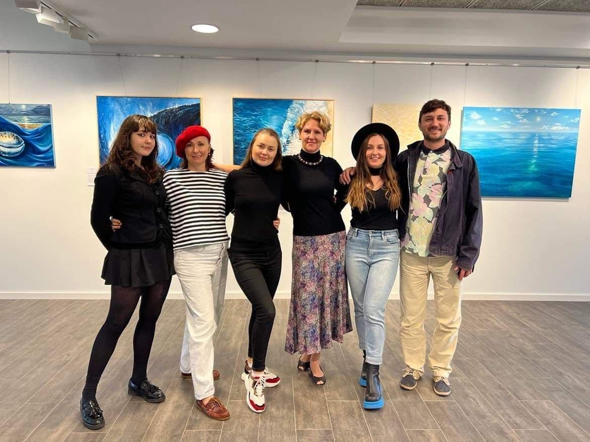 Artists in front of the artworks