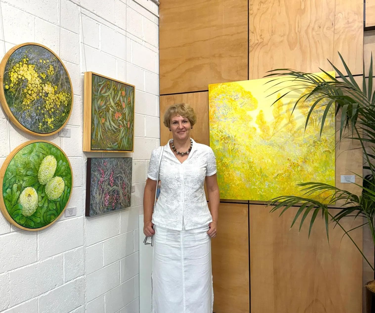 Artist at her exhibition presenting a contemporary Australian art collection available to buy online.