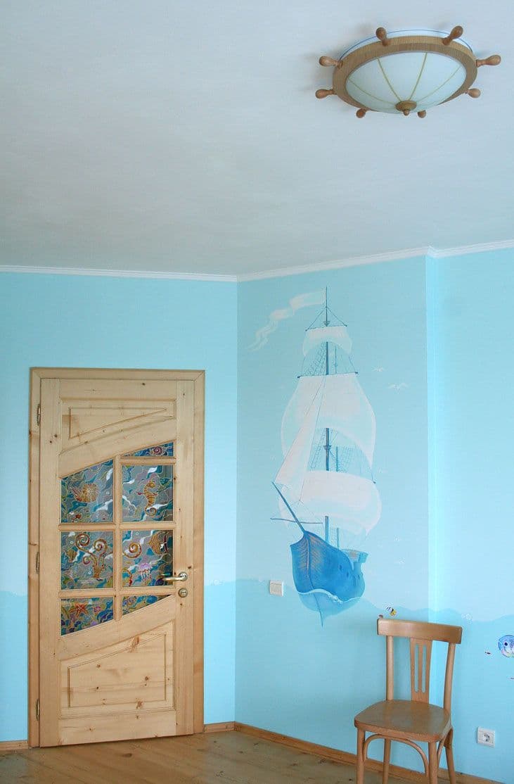 Kids bedroom with ocean theme and a sails boat