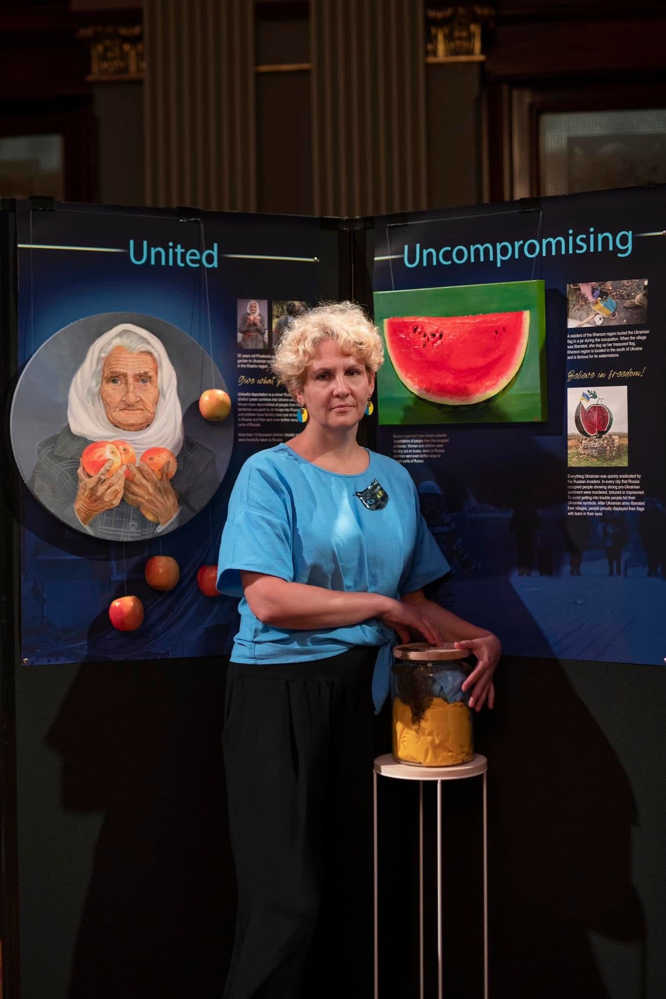 Artist in front of her artworks