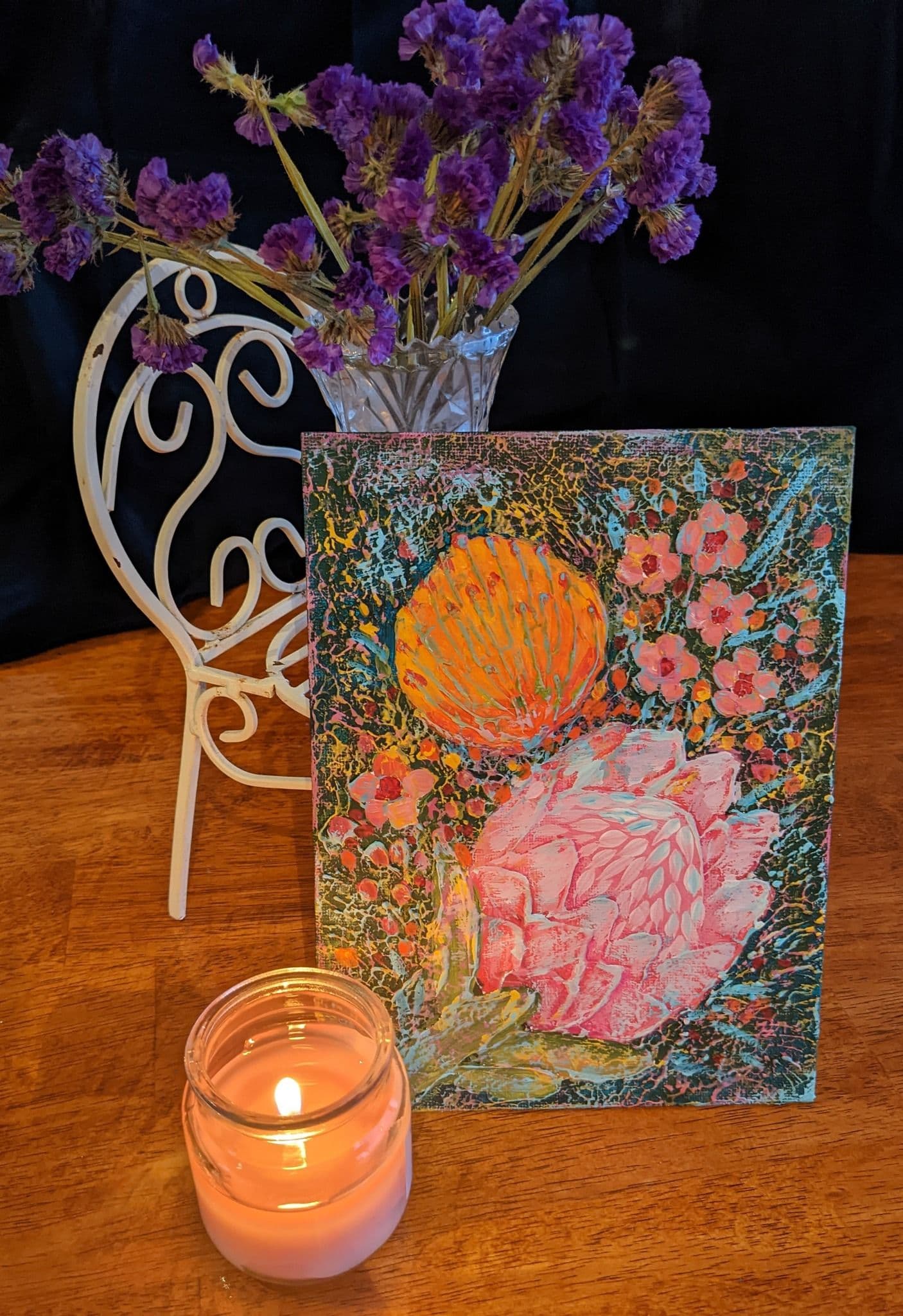 Candle in front of artwork