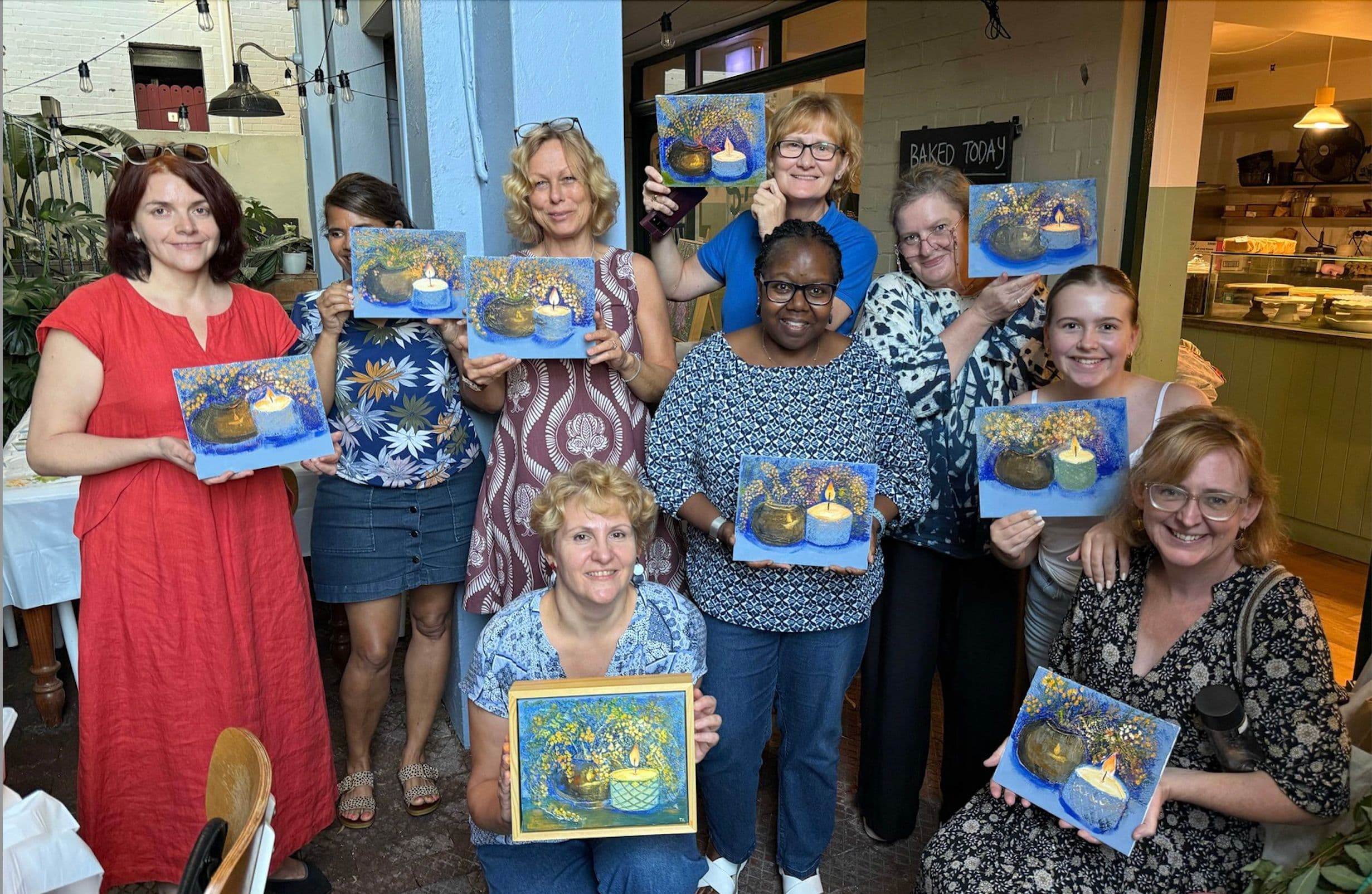 Participants holding their works