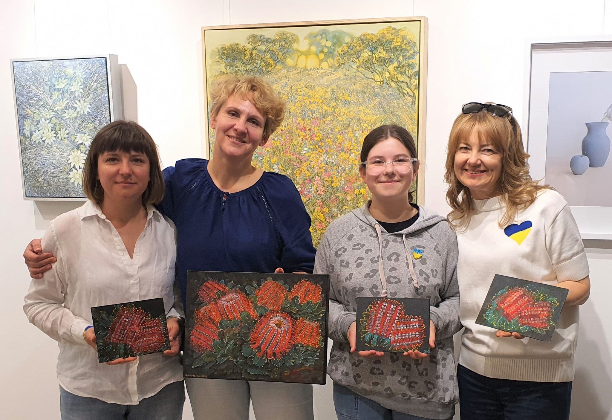 Artist and three participants with their results of the workshop
