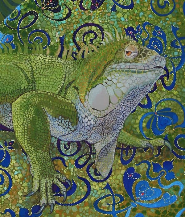 Green iguana looking at the viewer sitting on a highly ornate textile.