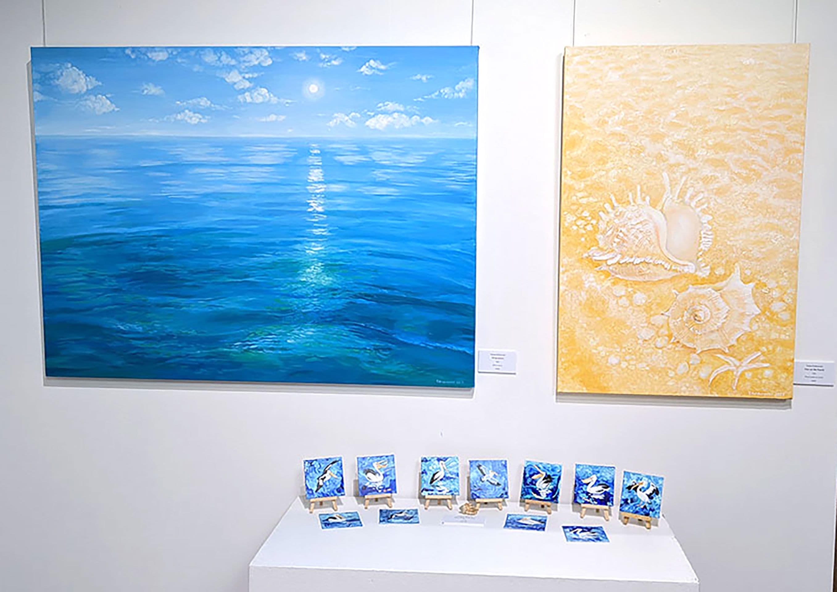 Blue and Yellow landscape paintings by Tetiana Koldunenko on the wall.